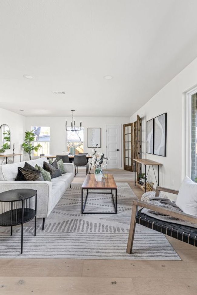 Living area with wood finished floors, a chandelier, and recessed lighting | Image 7