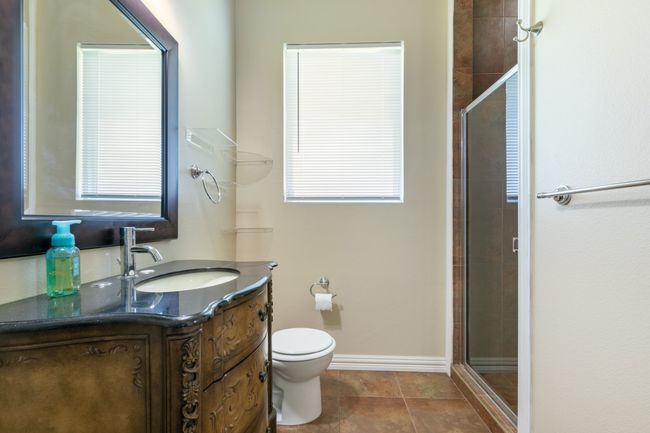 Full bath featuring vanity, a stall shower, and tile patterned floors | Image 14