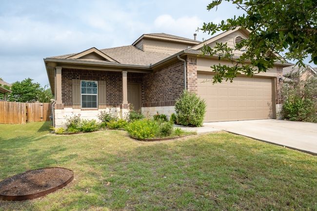 Ranch-style home with brick siding, a garage, driveway, and roof with shingles | Image 29