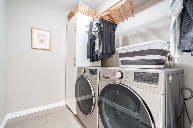 Laundry area featuring washer and clothes dryer and baseboards | Image 28