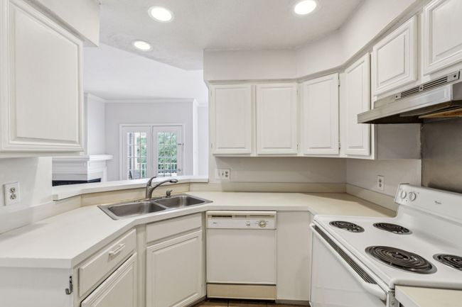 Kitchen featuring recessed lighting, a sink, under cabinet range hood | Image 17