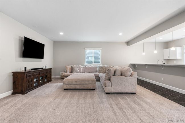 Full-size finished basement with 2nd kitchen area/wetbar complete with Samsung BeSpoke fridge and dishwasher, quartz countertops and plenty of cabinet storage. | Image 35