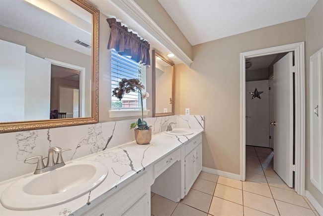 Beautifully updated, the upstairs bath boasts double vanities. | Image 28