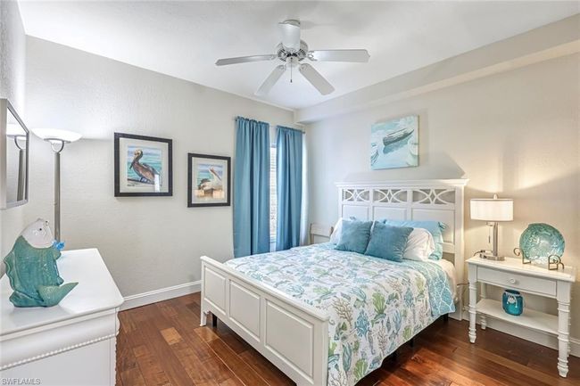 Bedroom with dark wood-type flooring and a ceiling fan | Image 14
