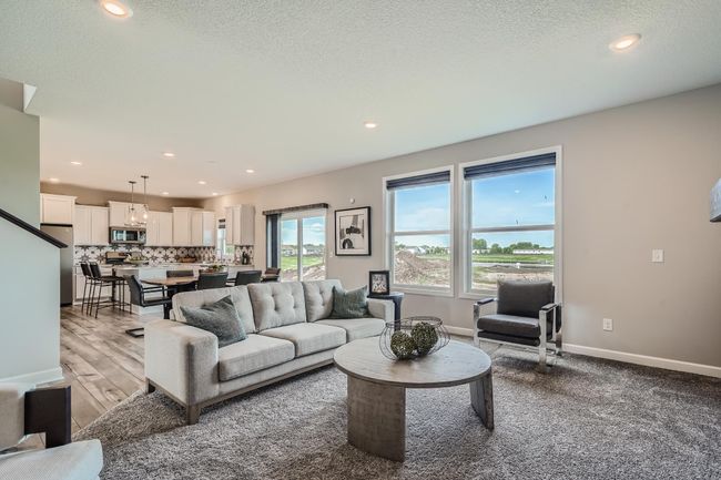 Photo is of the model. The main level seamlessly transitions from room to room while maintaining an open-concept layout throughout. | Image 6