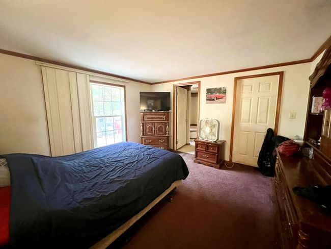 Primary bedroom featuring crown molding | Image 10