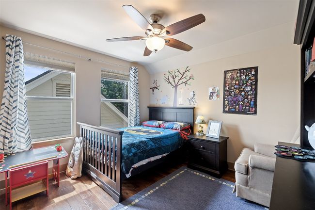 Bedroom featuring wood finished floors, a ceiling fan, and lofted ceiling | Image 23