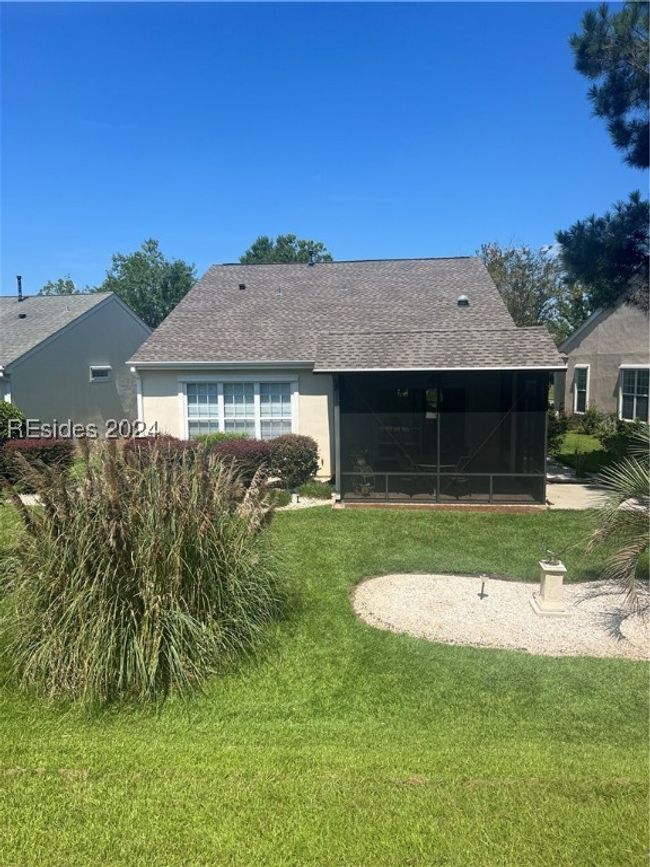 Back of property featuring a sunroom and a yard | Image 4