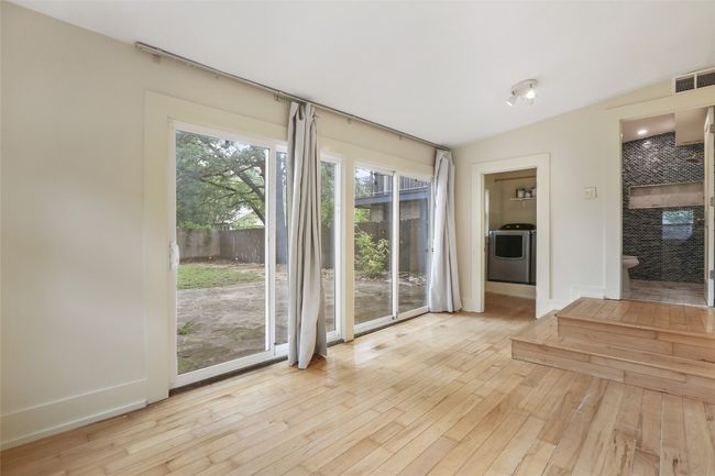 Spare room with washer / clothes dryer, hardwood / wood-style flooring, and vaulted ceiling | Image 23
