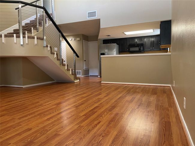 Unfurnished living room with dark hardwood / wood-style flooring | Image 9