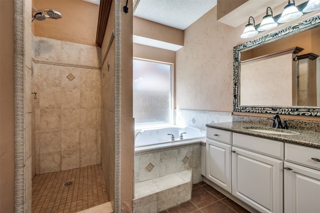 Bathroom featuring a garden tub, tile patterned flooring, a stall shower, and vanity | Image 20