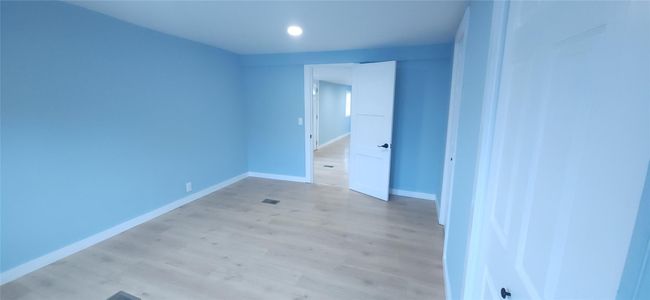 Unfurnished bedroom with light wood-style floors, baseboards, and recessed lighting | Image 25