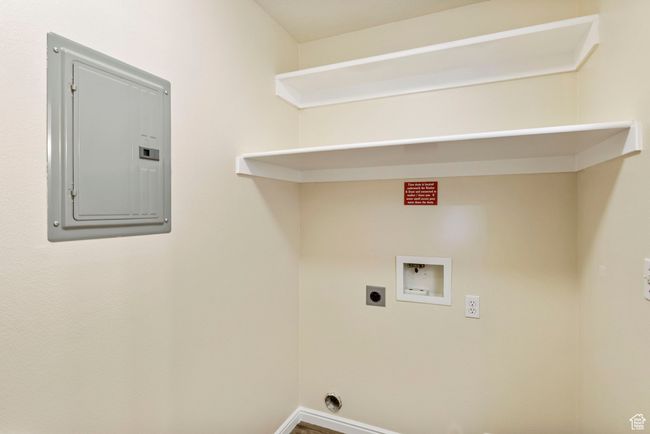 Clothes washing area with electric panel, washer hookup, hookup for an electric dryer, and baseboards | Image 11