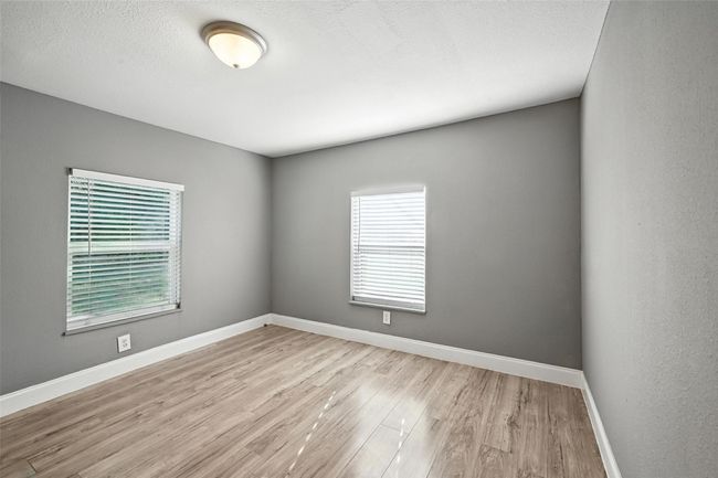 Spare room with healthy amount of natural light and light wood-style floors | Image 17