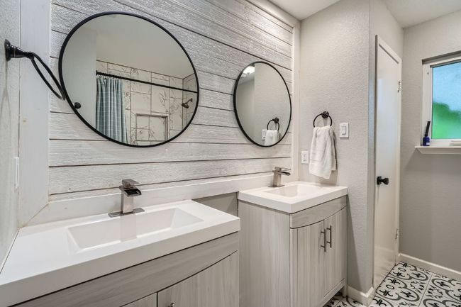Full bath featuring two vanities and wood walls | Image 23