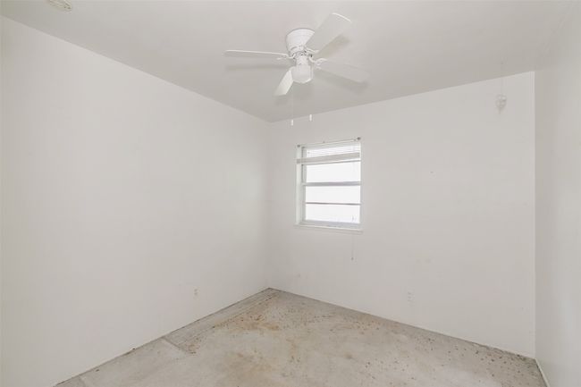 Spare room featuring unfinished concrete flooring and ceiling fan | Image 25
