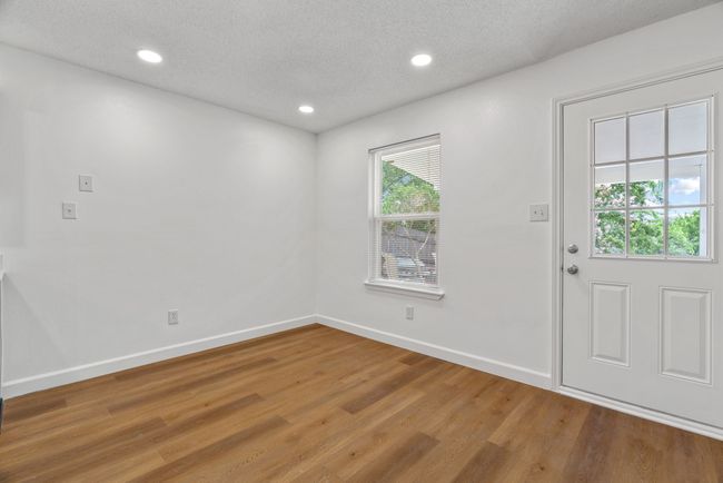 Foyer featuring wood finished floors, a textured ceiling, and recessed lighting | Image 8