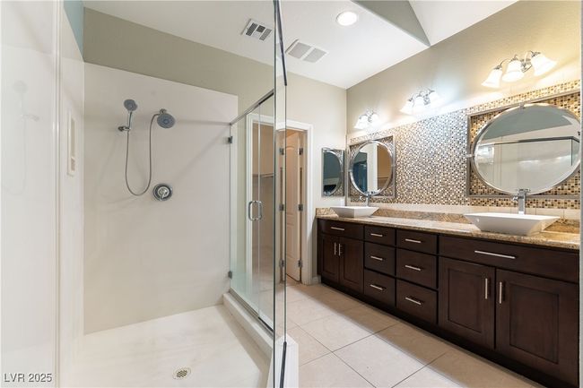 Full bath with a stall shower, backsplash, tile patterned flooring, and a sink | Image 30