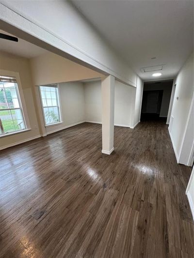 Unfurnished living room featuring dark wood-type flooring | Image 3