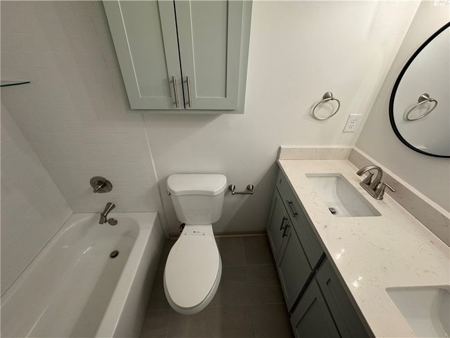 Shared bath with tub/shower & tiled walls with double vanity. Soft close cabinets. | Image 16