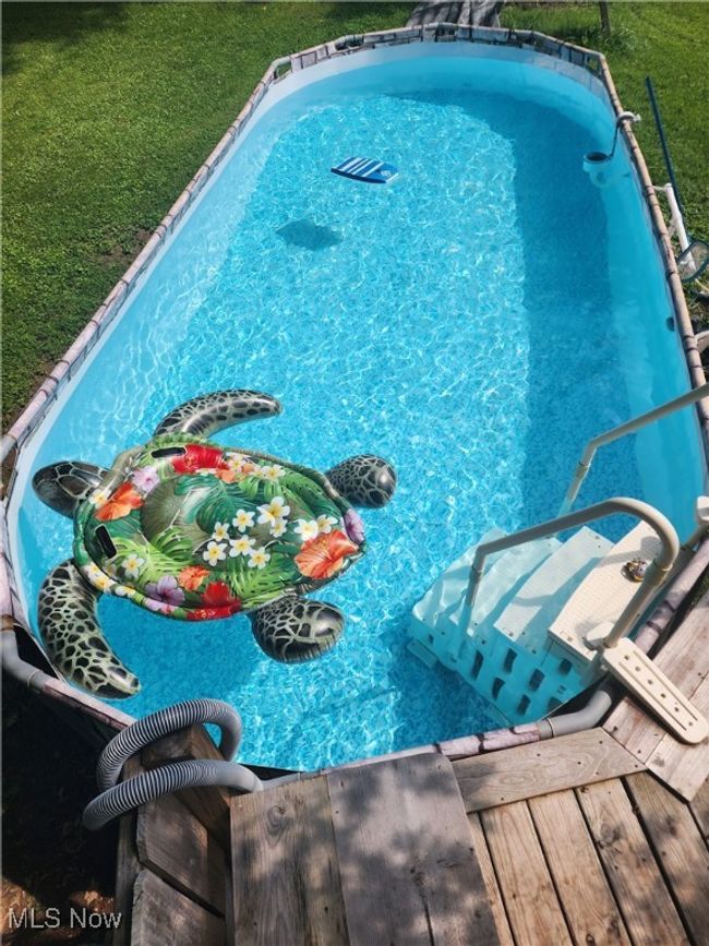Outdoor pool featuring a yard | Image 36