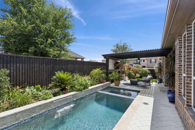 View of pool with a fenced backyard, a patio, and a pool with connected hot tub | Image 28