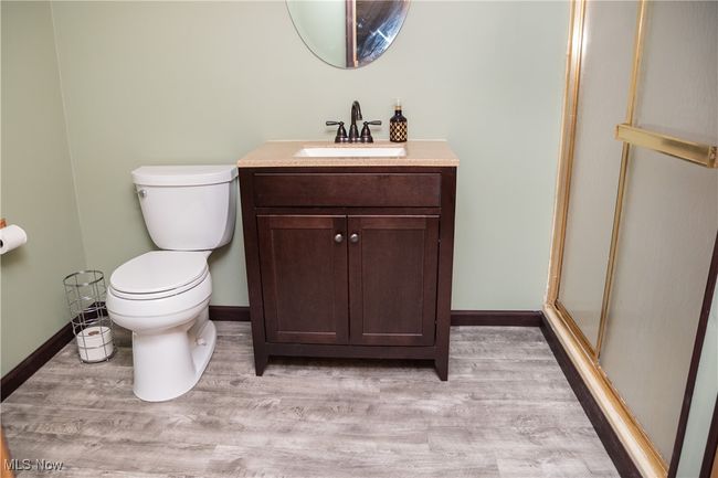 Bathroom featuring vanity, wood finished floors, and a stall shower | Image 44