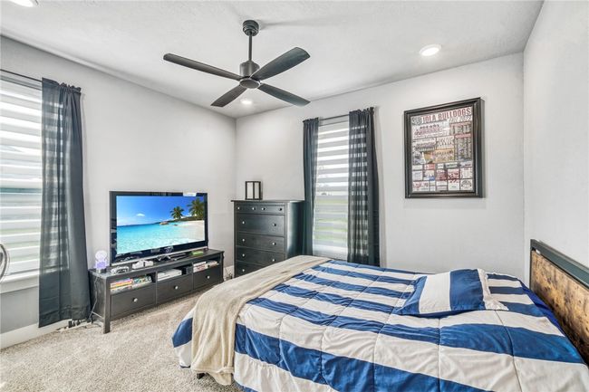 Bedroom with carpet and ceiling fan | Image 30