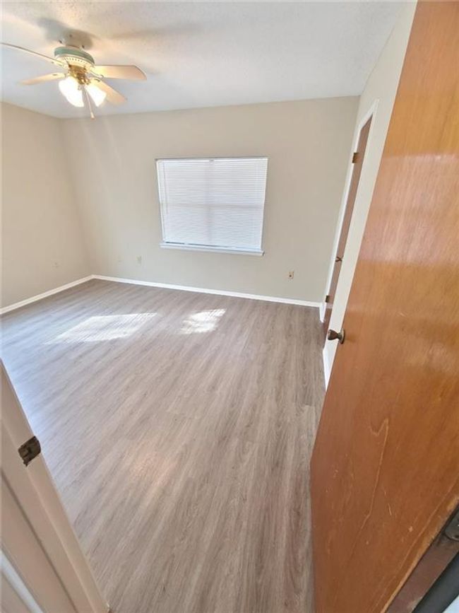 Spare room with wood finished floors and a ceiling fan | Image 8