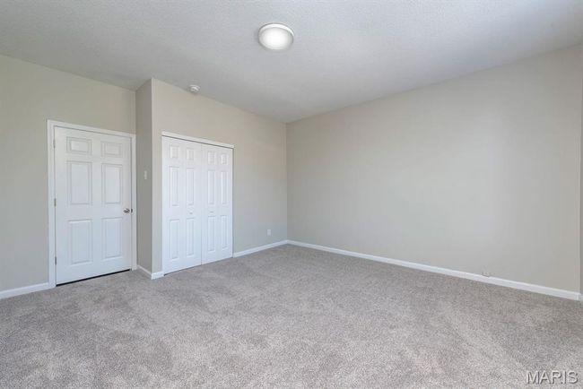 Unfurnished bedroom with carpet floors and a closet | Image 12