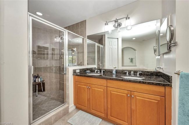 Full bath with double vanity, a shower stall, tile patterned floors, and recessed lighting | Image 23