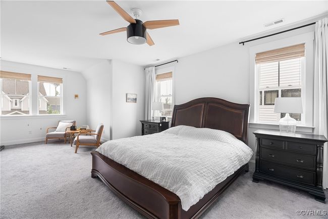Bedroom with light carpet, baseboards, and ceiling fan | Image 35