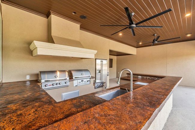 Outdoor kitchen offers a stainless steel gas grill and a charcoal grill for all of your grilling needs. A large power burner is also available for those weekend crawfish broils! | Image 37