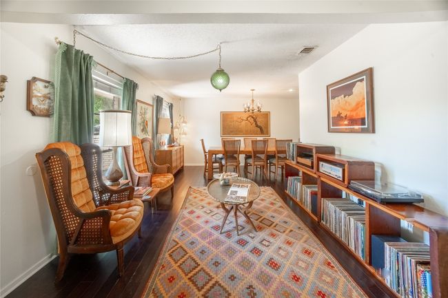 Living area with visible vents, hardwood / wood-style flooring, and baseboards | Image 6