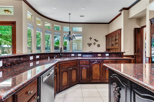 Naturally the kitchen enjoys pool and backyard views through the wall of windows in the breakfast nook. | Image 12