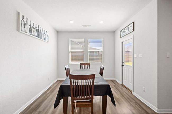 Dining space with baseboards, visible vents, and light wood-style flooring | Image 11