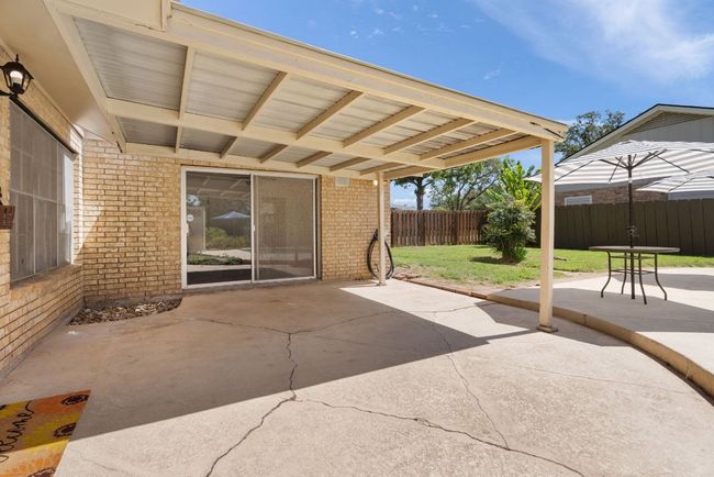 Fenced backyard with a patio | Image 26