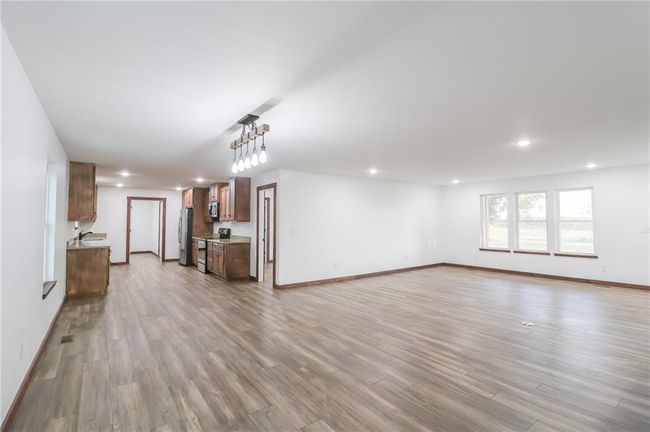 Unfurnished living room featuring light wood-type flooring | Image 11