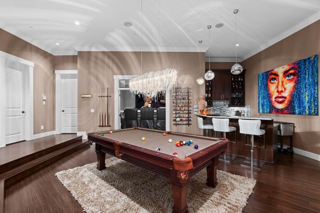 Rec room with crown molding, pool table, wood finished floors, baseboards, and recessed lighting | Image 13