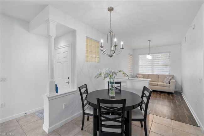 Dining space with decorative columns and light tile patterned floors | Image 8