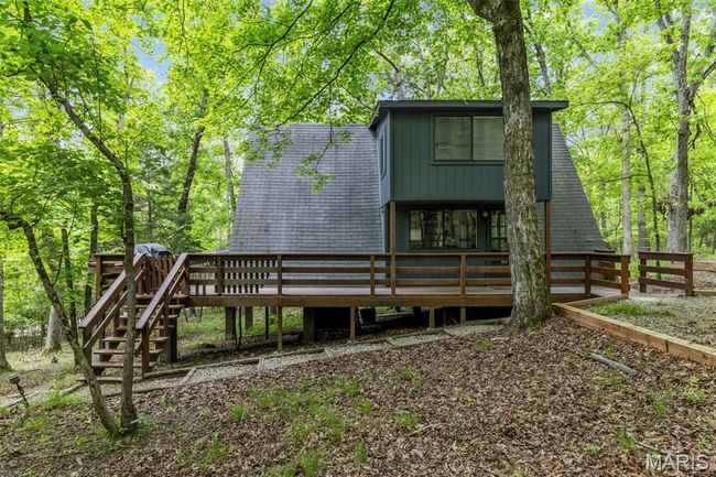 Back of property with a deck and fence | Image 48