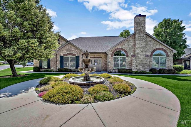 View of front of home featuring stone siding, a chimney, a front lawn, and roof with shingles | Image 22