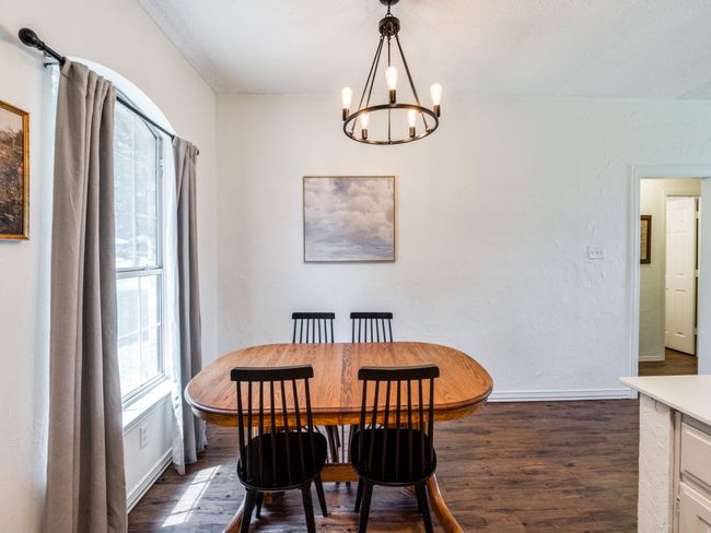 Dining space featuring a chandelier and dark wood finished floors | Image 14