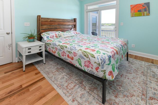 Bedroom featuring baseboards, wood finished floors, and access to exterior | Image 14