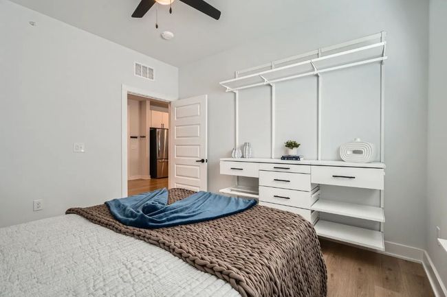 2nd Bedroom with freestanding refrigerator, wood finished floors, and a ceiling fan | Image 23