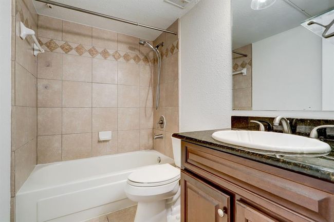En suite bathroom with granite counter. | Image 5
