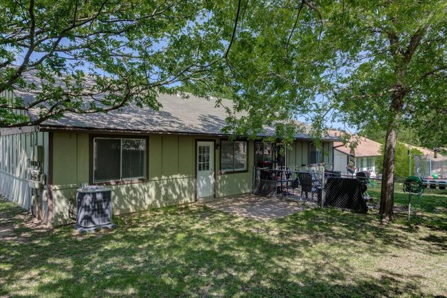 Back of house with a patio, roof with shingles, central AC unit, a yard, and fence | Image 20