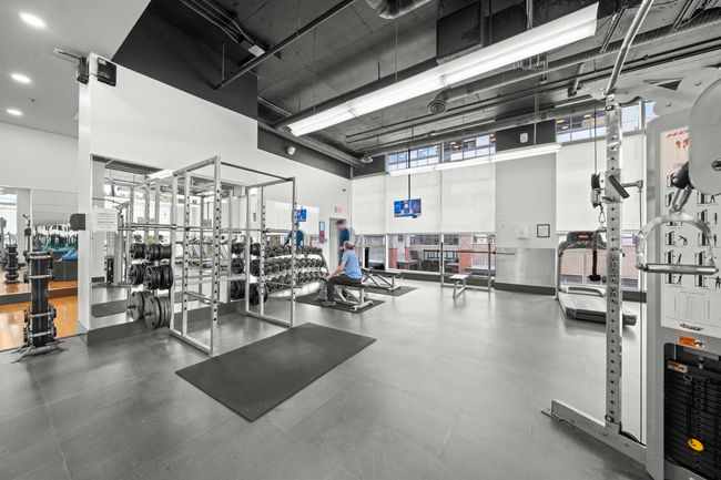 Exercise room with a towering ceiling | Image 27