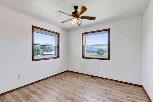 Spare room with healthy amount of natural light, light wood-style floors, and baseboards | Image 43
