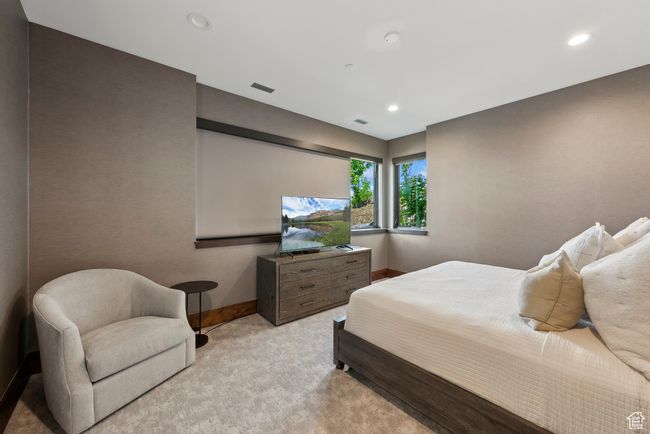 Bedroom featuring light carpet, baseboards, and recessed lighting | Image 97